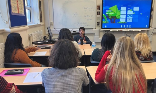 Freddy in front of a group of students in a classroom